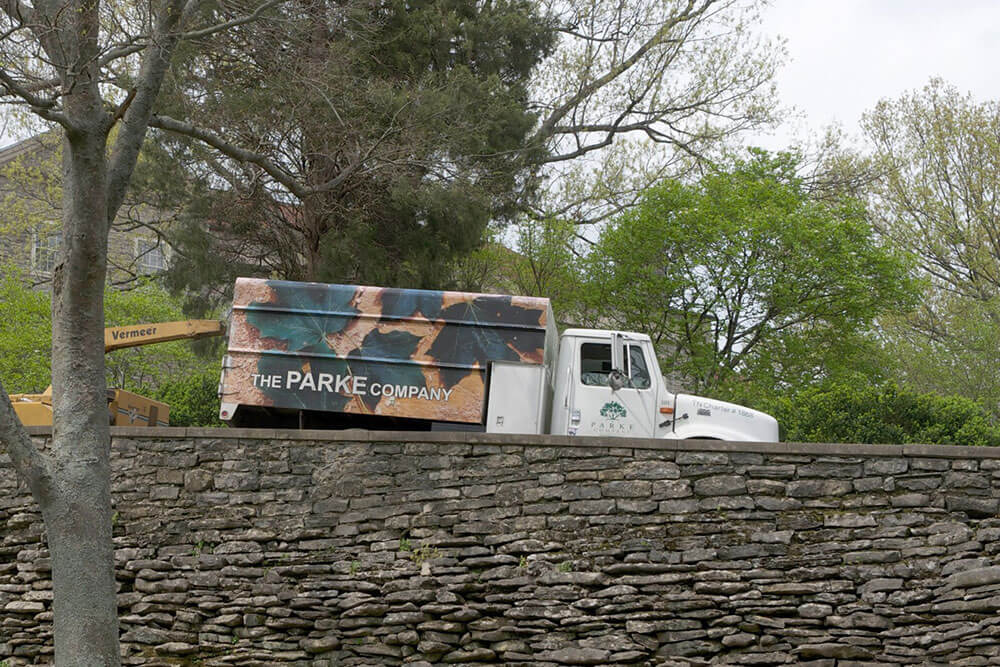 The Parke Company truck with wood chipper outside a water feature