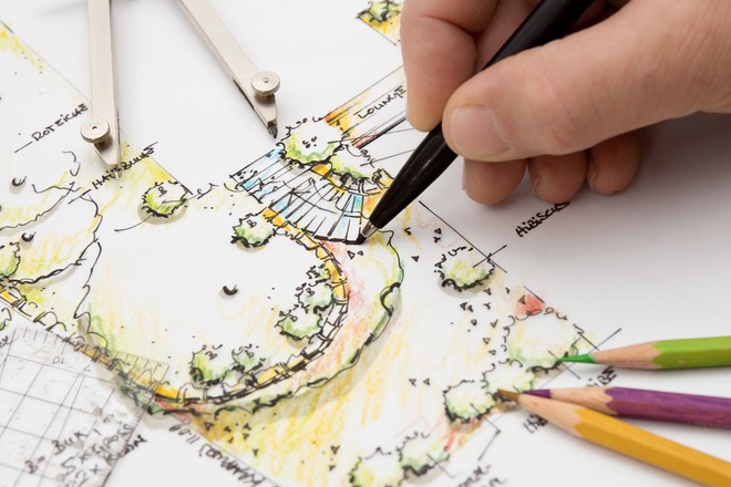 Person drawing a blueprint of a landscape
