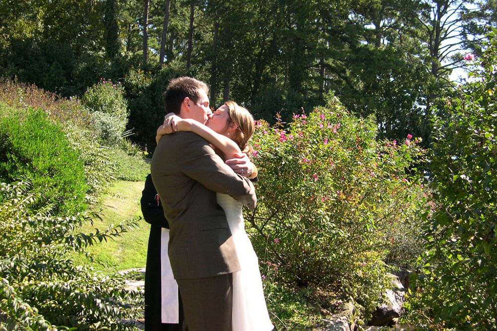 Bride and groom kissing in a backyard wedding
