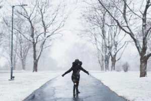 Woman on salted walkway in the snow