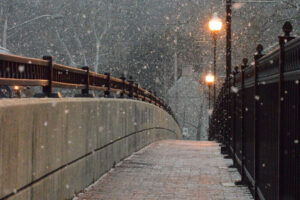 Snow falling on a walking bridge