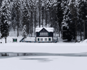 Outside of a house in the woods during the winter