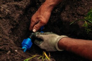 Man repairing an irrigation system.